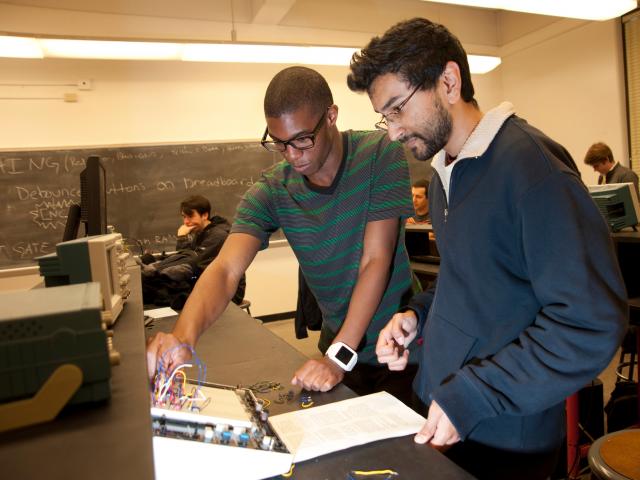 Two Students at a Workbench