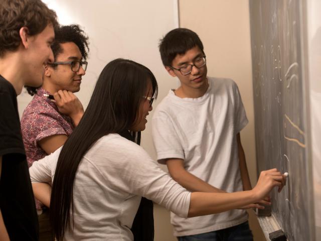 Students Doing Math at a Chalkboard