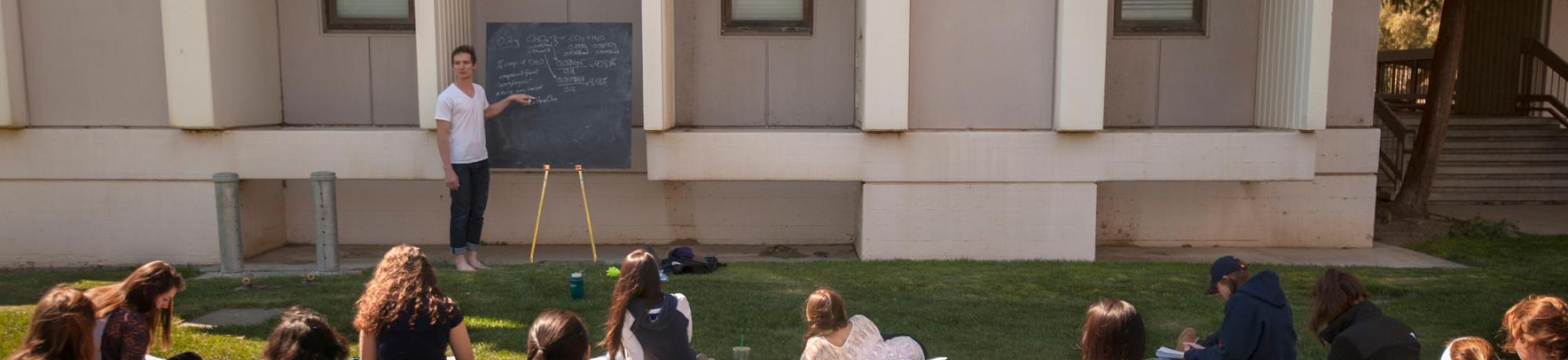 Person at a Chalkboard Explaining