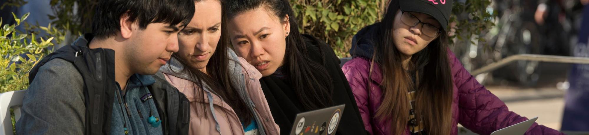 Group of Students Looking at Laptop