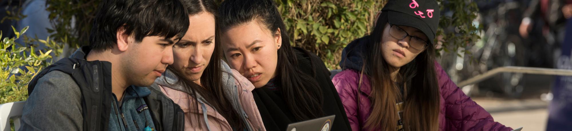 Group of Students Looking at Laptop